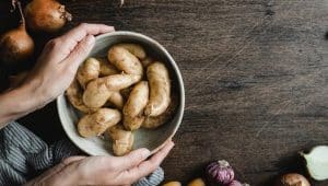 Woman Holding A Bowl Full Of Fresh Potatoes